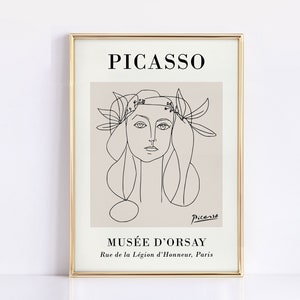 Puede incluir: Una impresi&oacute;n art&iacute;stica enmarcada con un dibujo lineal del rostro de una mujer, con el nombre "Picasso" en la parte superior. La impresi&oacute;n est&aacute; en un marco dorado e incluye el texto "Mus&eacute;e d'Orsay" y la direcci&oacute;n en Par&iacute;s.