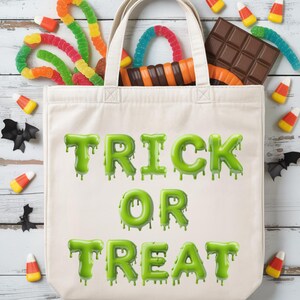 May include: A cream tote bag with the words "TRICK OR TREAT" in dripping green letters. The bag is filled with colourful sweets, including gummy worms, candy corn, and a chocolate bar. Black bat decorations are scattered around the bag.