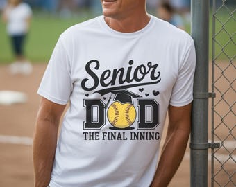 May include: White t-shirt with the text "Senior Dad" above a softball graphic and the words "The Final Inning." The shirt is worn by a person leaning against a chain-link fence.