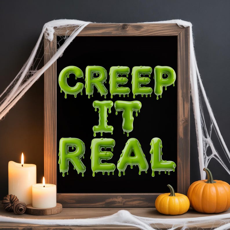 May include: A wooden framed chalkboard with the words "CREEP IT REAL" in green, dripping letters. The Halloween-themed decor includes lit candles, pumpkins, and spiderwebs.