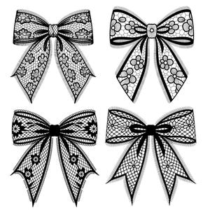 May include: Four black lace bows with floral patterns are displayed against a white background. Each bow has a distinct design, with variations in the size and arrangement of the floral details. The bows are symmetrical and detailed.