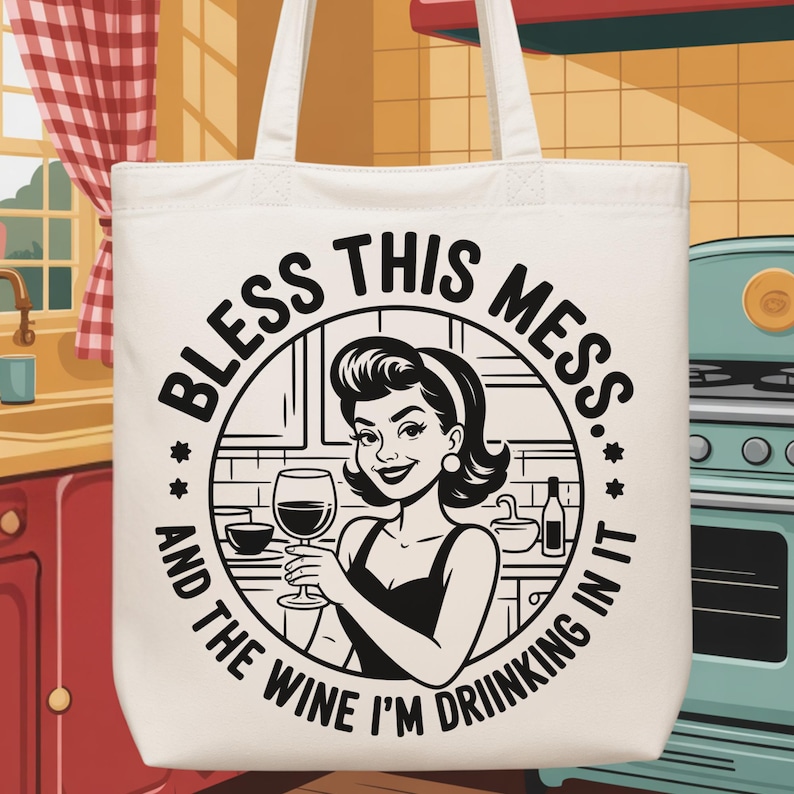 May include: Off-white tote bag with the text "BLESS THIS MESS...AND THE WINE I'M DRINKING IN IT." The graphic features a retro-style woman holding a wine glass. The bag has two white handles.