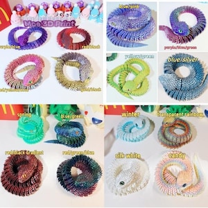 May include: A collection of 12 colorful, 3D printed, coiled snake-like figurines. Each figurine is a different color combination, including purple and blue, red and black, yellow and green, blue and silver, red and yellow, gold and black, spring green, blue and green, winter white, transparent rainbow, red and black gradient, red, green and blue, silk white, and candy.