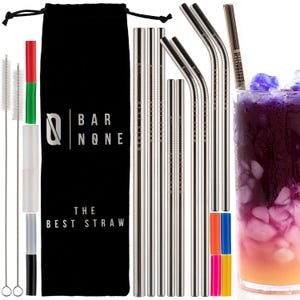 May include: A stainless steel straw set with straight and bent straws, cleaning brushes, and a carrying bag. The black bag has the text "BAR NONE THE BEST STRAW". A glass of purple and orange drink is on the right.