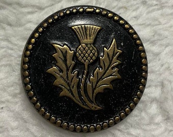 Antique Thistle Picture Button. Black Background with Brass Thistle. 1 Inch.