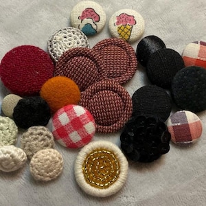 Lot of Material Buttons. Various Designs and Colors. 1950s to 80s. Sequins, Suede, Beads, Plaid, Pictures. 24 Total.