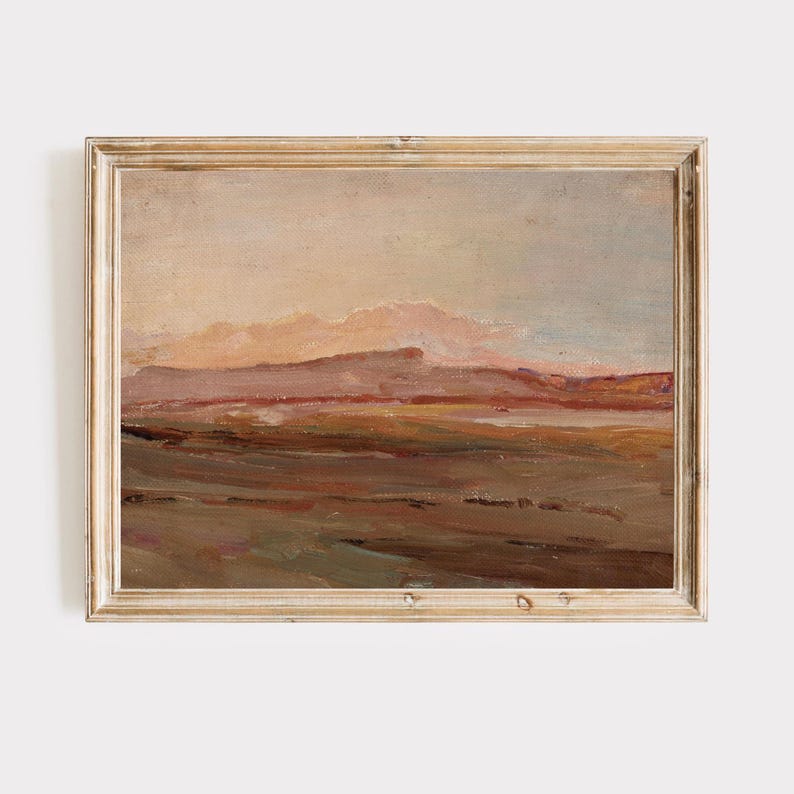 May include: An oil painting of a landscape with a warm color palette. The artwork features a muted sky, rolling hills, and a foreground of earthy tones. The painting is framed in a light-colored, ornate wooden frame.