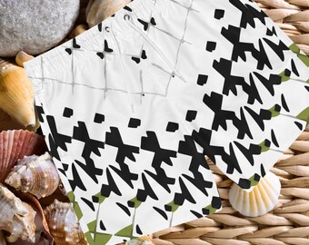 May include: White swim trunks with a black and white geometric pattern. The pattern is a series of diagonal lines and squares. The trunks have a drawstring waist.