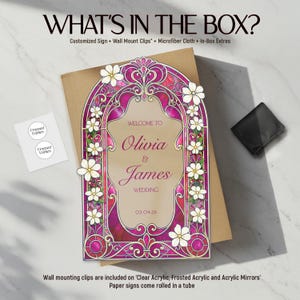 May include: A rectangular wedding sign featuring a stained-glass style border in shades of magenta and purple, decorated with white flowers. The text reads: WELCOME TO Olivia & James WEDDING 03.04.26. Includes a small white card with Framed Fables text.