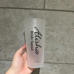 May include: A clear plastic cup with the text "Alisha Bride Squad" printed on it.