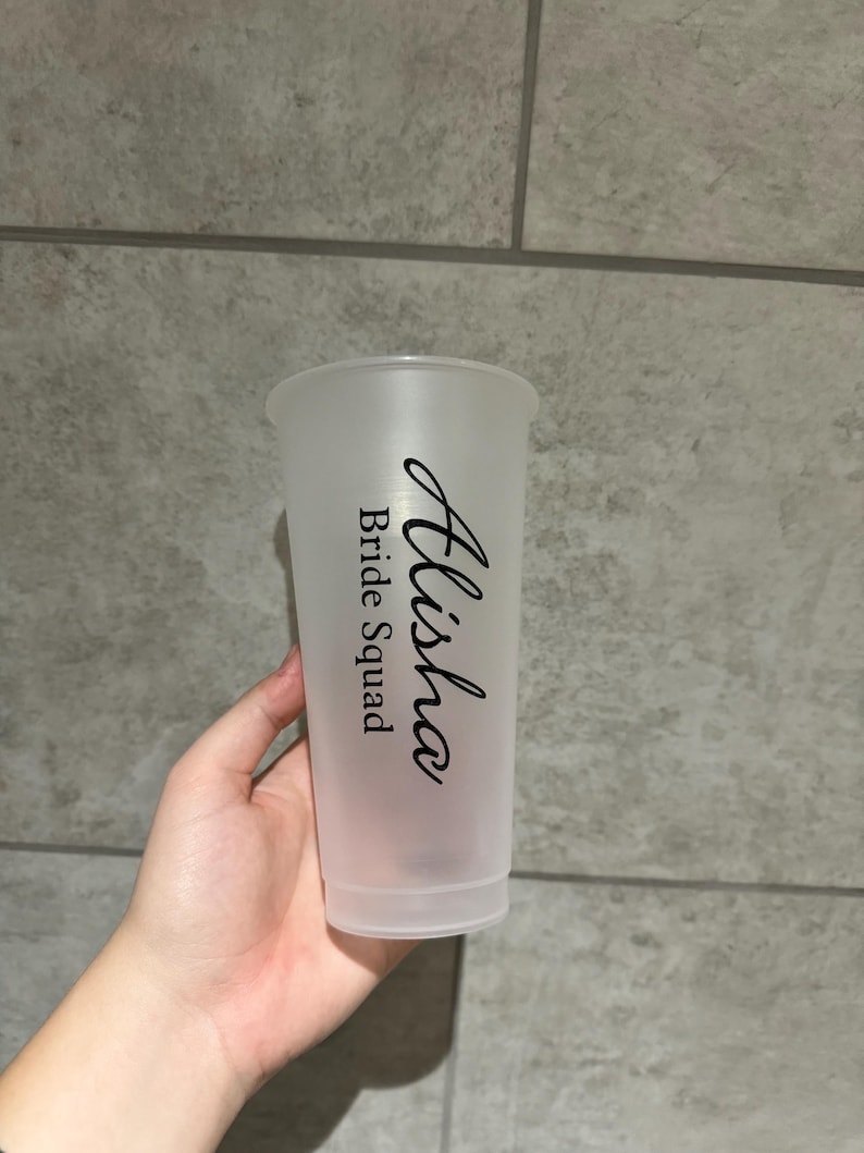 May include: A clear plastic cup with the text "Alisha Bride Squad" printed on it.