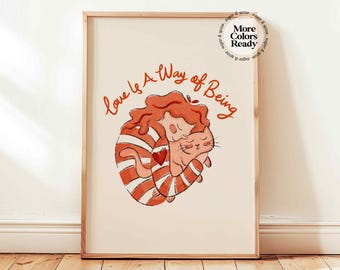 May include: A framed art print featuring an illustration of two embracing cats. The cats are in shades of orange and white, with a heart detail. The text "Love is a Way of Being" is written above the illustration.