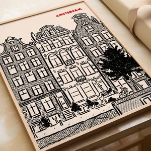 May include: Framed black and white illustration of Amsterdam buildings. The artwork features detailed architectural drawings of canal houses, with the city name in red at the top. The style is reminiscent of a comic book.