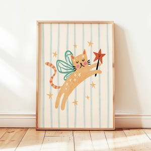May include: A framed wall art print featuring a light orange cat with teal fairy wings and a striped tail. The cat is holding a red star-shaped wand, surrounded by small yellow stars against a background of vertical light blue stripes.