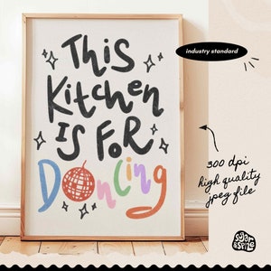 May include: A framed art print with the text "This Kitchen Is For Dancing" in a playful font. The word "Dancing" is in colorful letters, and a disco ball graphic is included. The print is in a wooden frame.