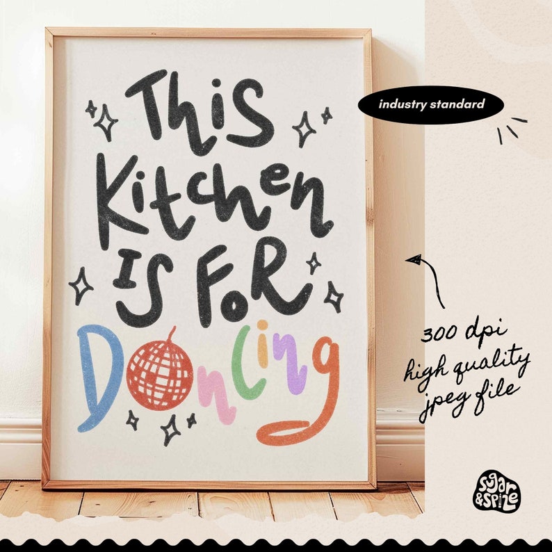 May include: A framed art print with the text "This Kitchen Is For Dancing" in a playful font. The word "Dancing" is in colorful letters, and a disco ball graphic is included. The print is in a wooden frame.