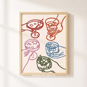 May include: A framed wall art print featuring a line drawing of five hands holding various cocktail glasses filled with ice. The illustration uses red, pink, blue, and green outlines on a cream background. The text sugar & spize is at the bottom.