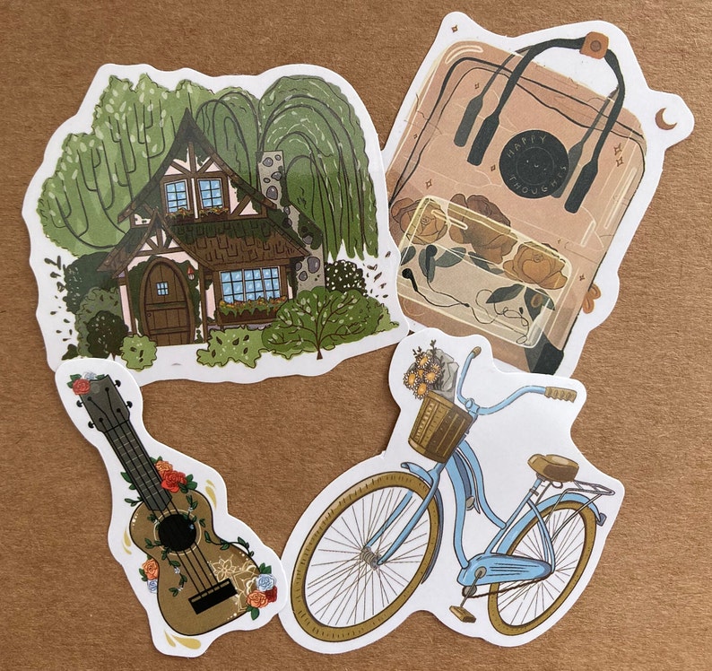 May include: Four stickers featuring a cottage with trees, a bicycle with a basket of flowers, a ukulele with floral accents, and a clear backpack with the text "Happy Thoughts".