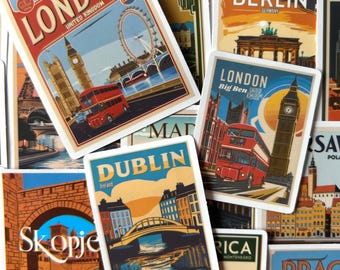 May include: A collection of travel-themed stickers featuring iconic landmarks. Stickers include images of London, Berlin, Dublin, and other cities. Each sticker has a vintage travel poster design with city names and landmarks.