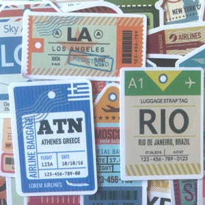 May include: A collection of vintage-style travel stickers and luggage tags. The tags feature destinations like Los Angeles, Athens, and Rio de Janeiro, with details such as flight numbers, dates, and airline information. The color palette includes blue, orange, and green.