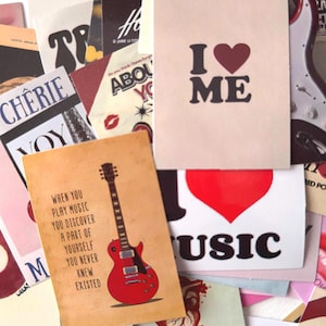May include: A collection of vintage-style cards with various designs. One card reads "I ❤️ ME" in black text with a red heart. Another features a red guitar and the quote, "When you play music you discover a part of yourself you never knew existed."