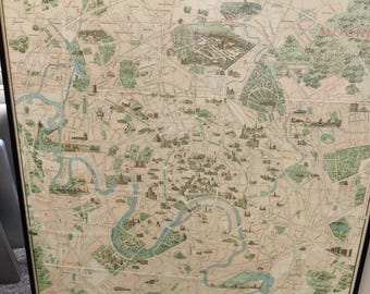 May include: Framed vintage map of Moscow, featuring a detailed depiction of the city's layout. The map showcases the Moscow River in blue, with green areas representing parks and forests. The map is framed in a black border.