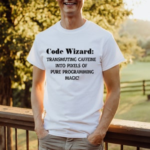 May include: White t-shirt with the text "Code Wizard: Transmuting caffeine into pixels of pure programming magic!"