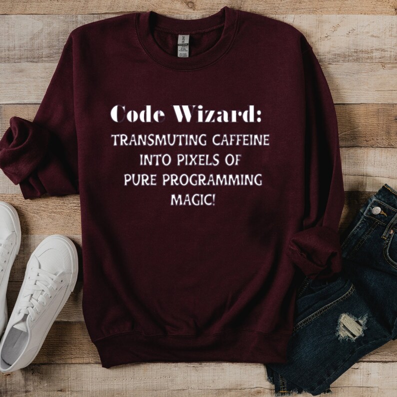 May include: Burgundy sweatshirt with white text that reads "Code Wizard: Transmuting caffeine into pixels of pure programming magic!"