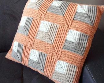 orange crochet cushion and cotton fabric