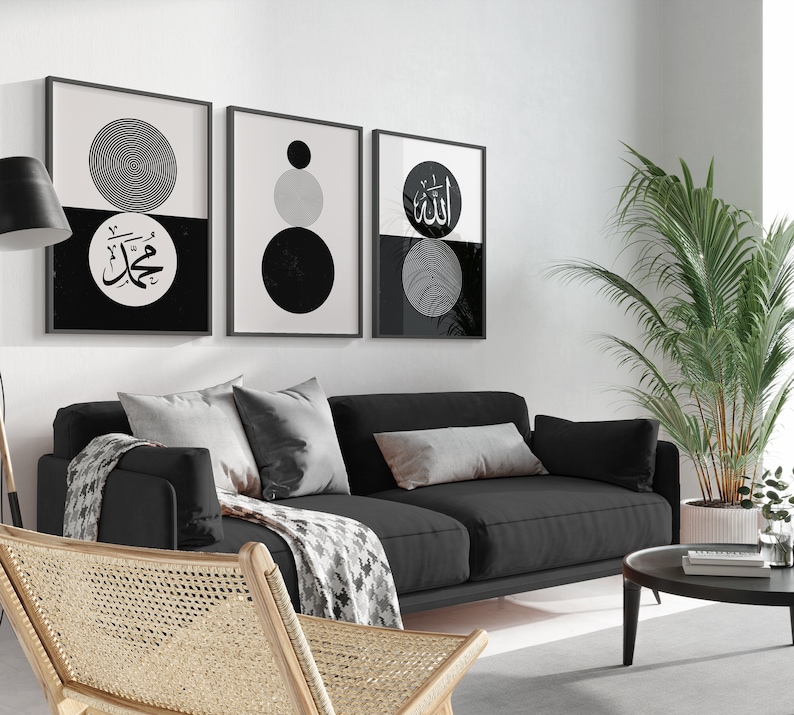 Peut inclure: Trois impressions encadr&eacute;es en noir et blanc avec des formes g&eacute;om&eacute;triques et de la calligraphie arabe. Les impressions sont accroch&eacute;es &agrave; un mur blanc au-dessus d'un canap&eacute; noir.