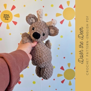 May include: Crochet pattern for Dash the Deer, a brown crocheted deer with large black eyes and a beige nose. The pattern is available in English and is a PDF download.