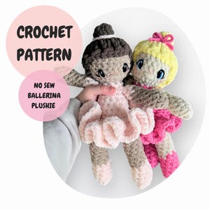 May include: Crochet pattern for a no-sew ballerina plushie. Two crocheted ballerina dolls, one with brown hair and a pink dress, the other with blonde hair and a pink dress.