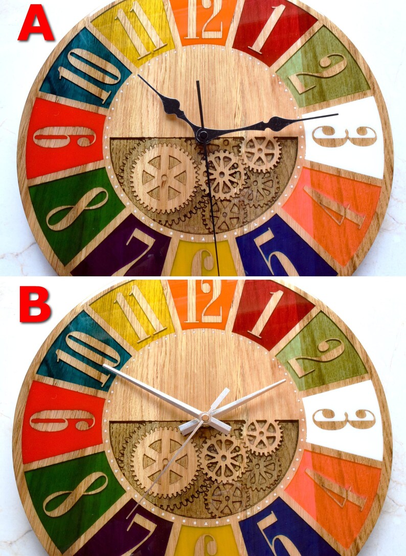 May include: A colorful wooden clock with Roman numeral hour markers and a gear design in the center. The clock has a black and white hand set in the first image and a white hand set in the second image.