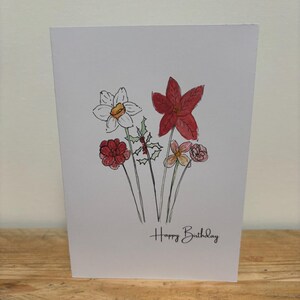 Una tarjeta de cumpleaños con flores de diciembre diseñada para ella.