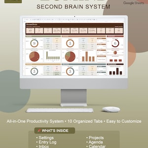 May include: A computer monitor displaying a productivity system interface. The screen shows data visualizations and the text "LUMIND SECOND BRAIN SYSTEM." Additional text includes "All-in-One Productivity System" and "10 Organized Tabs." The interface includes sections for Settings, Projects, and Goals.