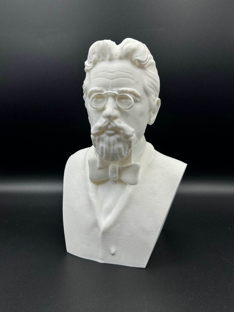 May include: A white 3D printed bust of a man with a mustache and glasses wearing a bow tie.