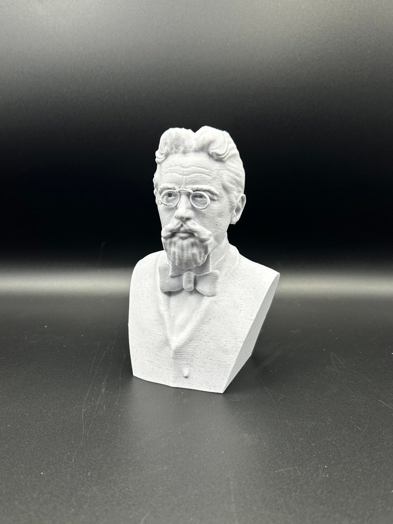 May include: A white 3D printed bust of a man with a mustache and glasses wearing a bow tie.