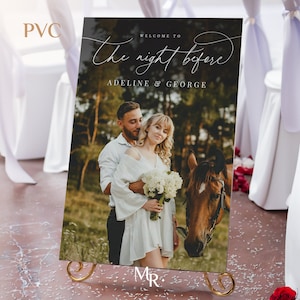 May include: A rectangular PVC wedding welcome sign featuring a photograph of a couple and a brown horse in a forest setting. The text reads Welcome to The night before ADELINE & GEORGE. The sign is displayed on a gold metal stand.