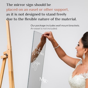 May include: A rectangular mirror sign featuring the white script text Welcome Sign and the letters MR. The mirror is flexible and requires an easel or wall mount brackets for display. The text states it should be placed on an easel or support.