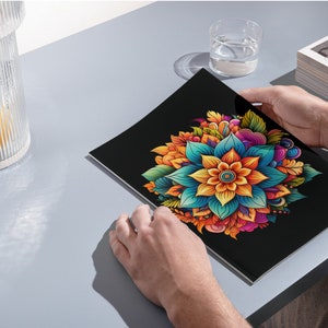 Puede incluir: Un dise&ntilde;o de mandala colorido con una gran flor naranja brillante en el centro rodeada de p&eacute;talos azules, verdes y morados. El dise&ntilde;o est&aacute; sobre un fondo negro.