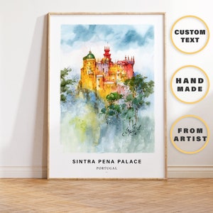 May include: Framed watercolour print of Sintra Pena Palace in Portugal. The artwork depicts the colourful palace on a hilltop, surrounded by trees and a cloudy sky. The print includes the text "Sintra Pena Palace, Portugal."
