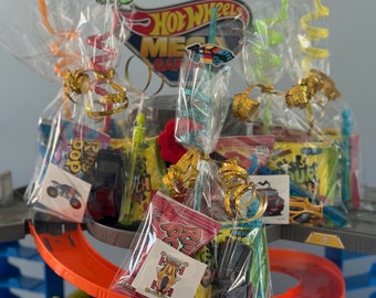 May include: A Hot Wheels Mega Garage playset with several small bags of candy and toys wrapped in clear cellophane bags with colorful straws. Each bag has a small Hot Wheels car sticker attached.
