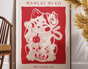 May include: A framed art print featuring a red and white illustration of a Maneki Neko, or Japanese lucky cat. The cat is depicted with a raised paw, a bell, and a Daruma doll. The text "MANEKI NEKO" and "THE FORTUNE CAT" are also visible.