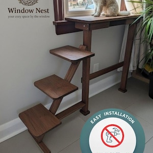 May include: A wooden pet window perch with steps. The dark brown perch has a top platform and three lower steps. The image includes the text "Window Nest" and "Easy Installation". A small dog sits on the top platform.