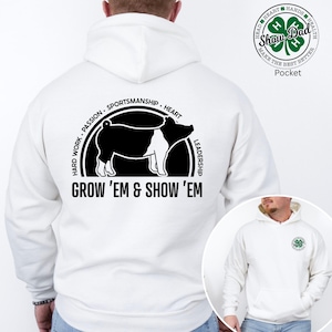 May include: White hoodie with a black and white pig graphic and the text "GROW 'EM & SHOW 'EM". The back of the hoodie features a circular design with the words "HARD WORK, PASSION, SPORTSMANSHIP, HEART, LEADERSHIP". A smaller graphic is on the front.