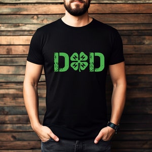 May include: A black t-shirt with a distressed green 4-H clover and the word "DAD" in white.