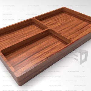 Puede incluir: Una bandeja rectangular de madera con un rico patrón de vetas marrones y tres compartimentos interiores distintos. La bandeja tiene un acabado liso con bordes elevados, proporcionando un espacio de almacenamiento organizado para objetos pequeños.