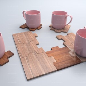 May include: Four pink ceramic mugs with handles are placed on wooden puzzle piece coasters. The coasters are made of light and dark brown wood.