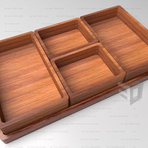 May include: A wooden tray with four rectangular compartments. The tray is made of light brown wood and has a dark brown border.