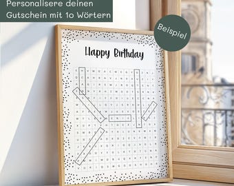 May include: A framed word search puzzle with the words "Happy Birthday" in black. The puzzle is in a white frame with black polka dots. The image also includes text in German.